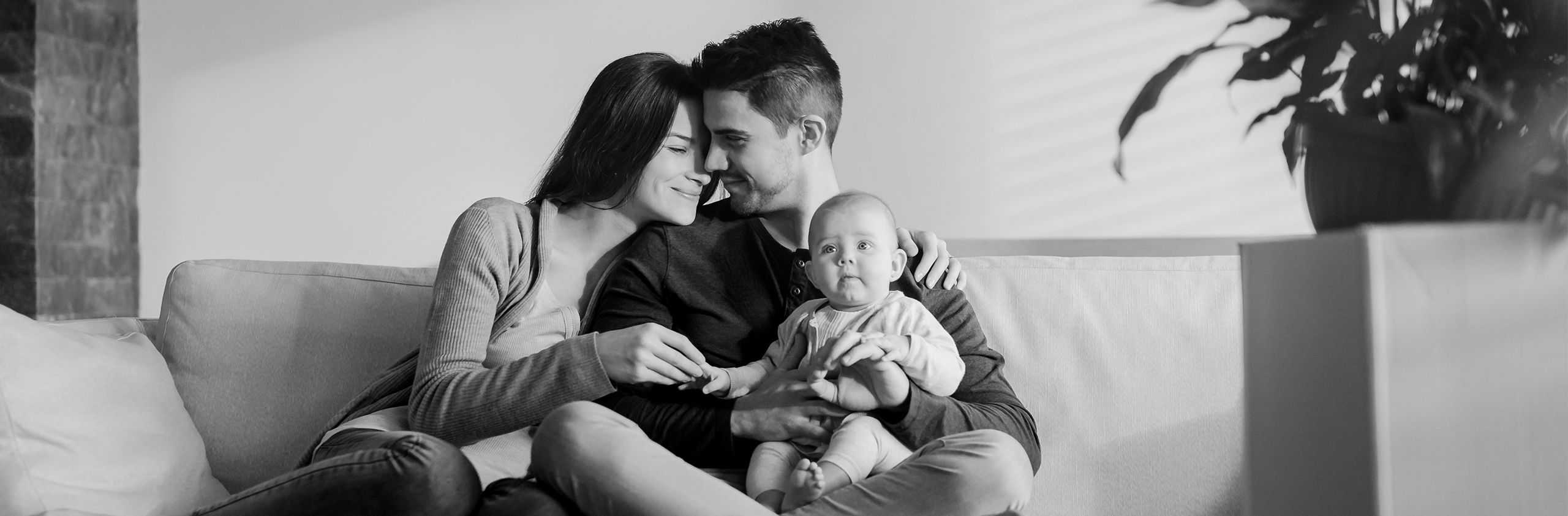 a happy family with baby on couch